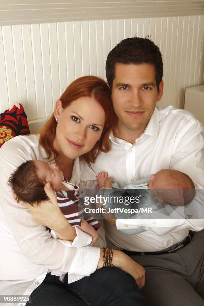 Molly Ringwald, her husband Panio Gianopoulos and their new twins Adele Georgina and Roman Stylianos pose during a photo shoot on July 29, 2009 in...