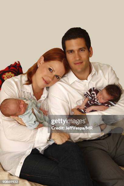 Molly Ringwald, her husband Panio Gianopoulos and their new twins Adele Georgina and Roman Stylianos pose during a photo shoot on July 29, 2009 in...
