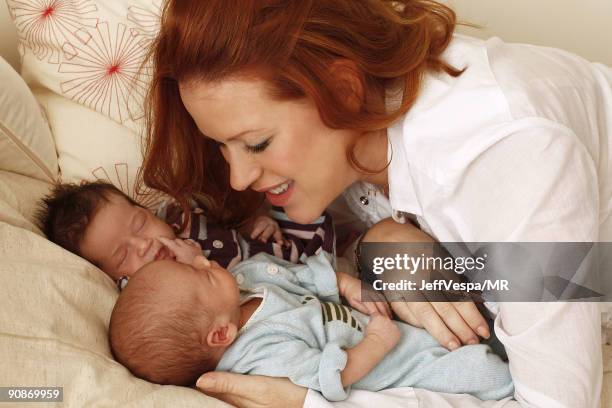 Molly Ringwald poses with her new twins Adele Georgina and Roman Stylianos during a photo shoot on July 29, 2009 in Los Angeles, California.