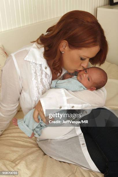 Molly Ringwald poses during a photo shoot with her newborn son Roman Stylianos on July 29, 2009 in Los Angeles, California.