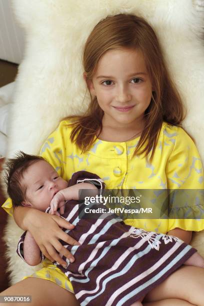 Mathilda Ereni, daughter of Molly Ringwald and her husband Panio Gianopoulos, poses with her newborn sister Adele Georgina during a photo shoot on...