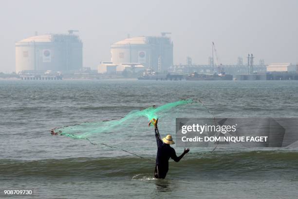 This photograph taken on January 6, 2018 shows a fisherman launching a net on the shores of Fort Kochi, in the southern Indian state of Kerala.