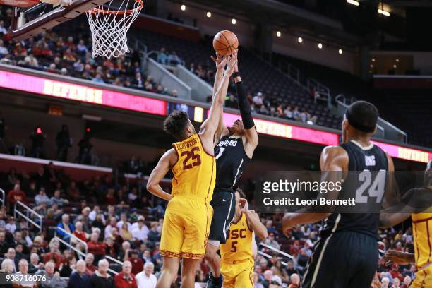 Tyler Bey of the Colorado Buffaloes handles the ball against Bennie Boatwright of the USC Trojans during a PAC12 college basketball game at Galen...