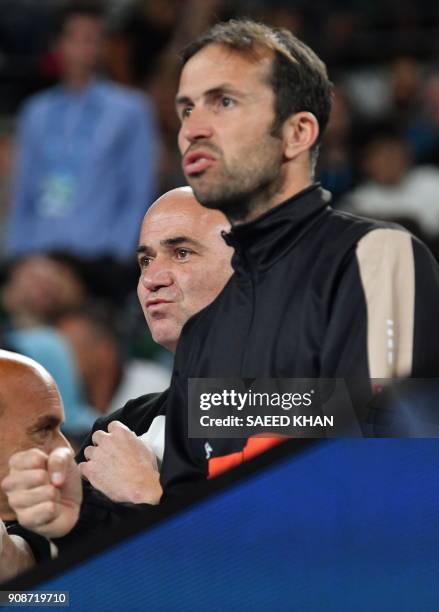 Coaches Radek Stepanek and Andre Agassi watch Serbia's Novak Djokovic play South Korea's Hyeon Chung during their men's singles fourth round match on...