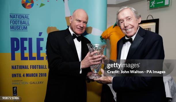 Chairman of the FWA Patrick Barclay presents the trophy to Gordon Banks on behalf of Pele, next to the National Football Museum signage advertising a...