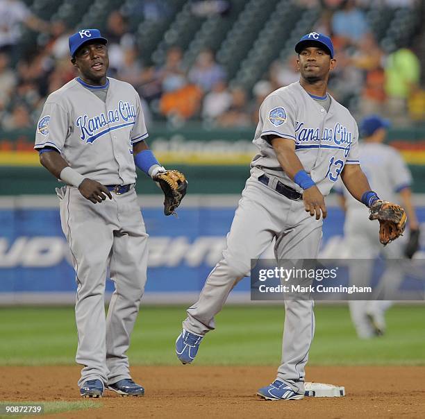 Yuniesky Betancourt and Alberto Callaspo of the Kansas City Royals warm-up between innings against the Detroit Tigers during the game at Comerica...