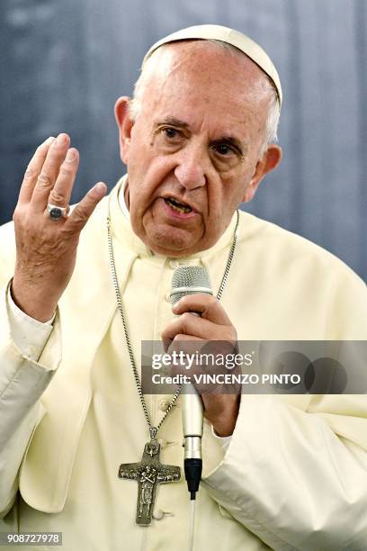 Pope Francis answers journalists during a press conference on board of the plane on January 22 during his flyback of a seven days trip to Chile and...