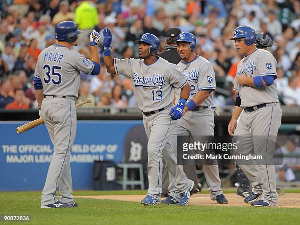 Alberto Callaspo of the Kansas City Royals gets a high-five from teammate Mitch Maier after hitting a 3-run homerun in the 1st inning against the...