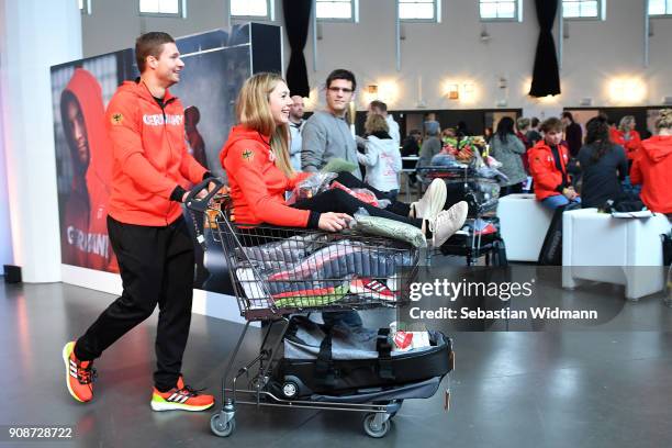Johannes Lochner pushes Carolin Langenhorst in a shopping cart during the 2018 PyeongChang Olympic Games German Team kit handover at Postpalast on...