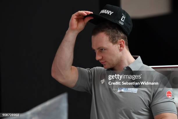 Francesco Friedrich tries on a hat during the 2018 PyeongChang Olympic Games German Team kit handover at Postpalast on January 22, 2018 in Munich,...