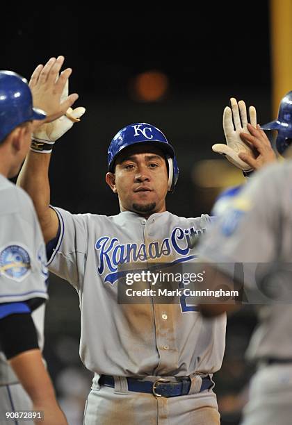 Miguel Olivo of the Kansas City Royals gets high-fives from teammates after hitting a 3-run homerun in the 7th inning against the Detroit Tigers...