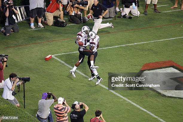 Brian Maddox of the South Carolina Gamecocks is congratulated by Moe Brown after scoring a touchdown against the Georgia Bulldogs at Sanford Stadium...