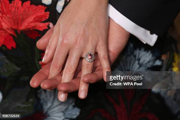 Princess Eugenie wears a ring containing a padparadscha sapphire surrounded by diamonds as she poses with Jack Brooksbank in the Picture Gallery at...