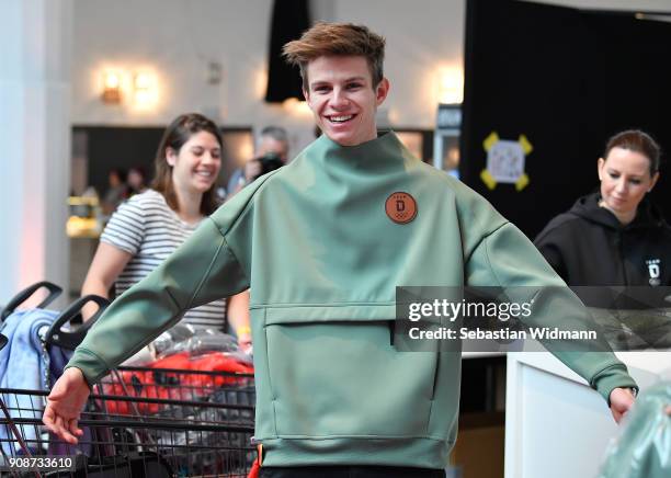 Andreas Wellinger tries on a sweatshirt during the 2018 PyeongChang Olympic Games German Team kit handover at Postpalast on January 22, 2018 in...