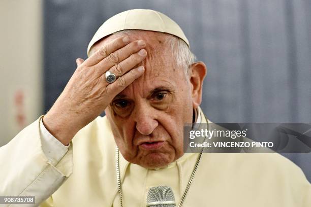 Pope Francis answers journalists during a press conference on board of the plane on January 22 during his flyback of a seven days trip to Chile and...