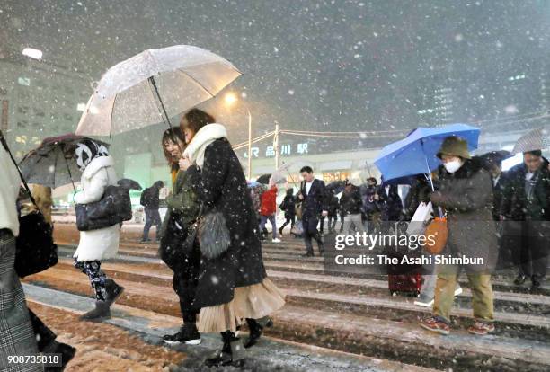 Pedestrian walk a crossing in front of Shinagawa Station on January 22, 2018 in Tokyo, Japan. The Japan Meteorological Agency is forecasting 20 cm of...