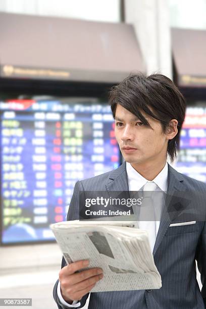 businessman holding newspaper - center for asian american media stock pictures, royalty-free photos & images