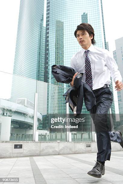 businessman running in city - businessman running stock pictures, royalty-free photos & images