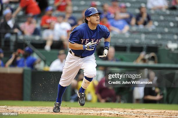 Ian Kinsler of the Texas Rangers runs to first base after hitting the ball during the game against the Seattle Mariners at Rangers Ballpark in...