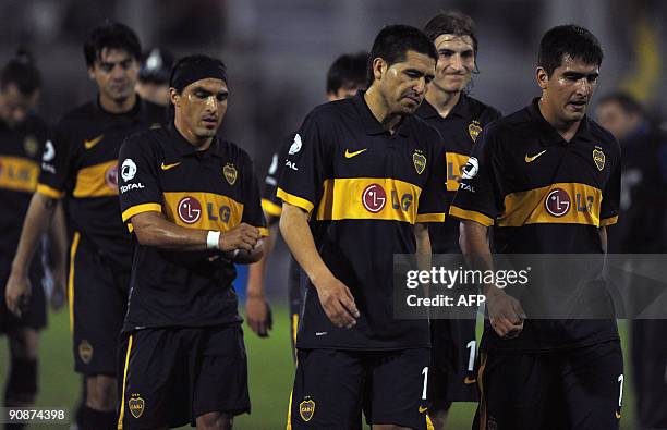 Argentina's Boca Juniors footballers Julio Cesar Caceres, Claudio Morel Rodriguez, Juan Roman Riquelme, Gabriel Paleta and Lucas Viatri leave the...