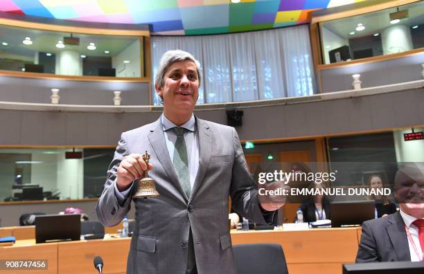 New Eurogroup Portuguese President Mario Centeno rings a symbolic bell as he presides over his first Eurogroup finance ministers meeting on January...