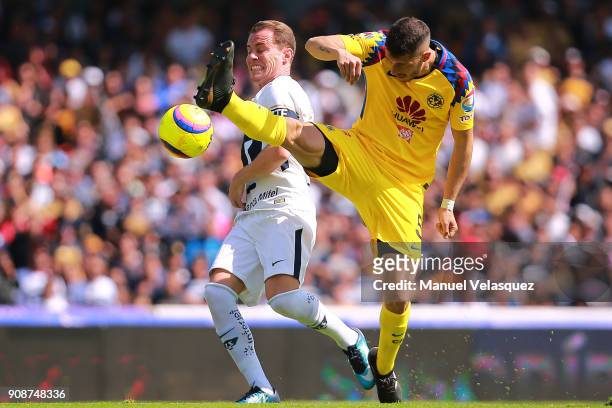Abraham Gonzalez of Pumas struggles for the ball with Guido Rodriguez of America during the 3rd round match between Pumas UNAM and America as part of...