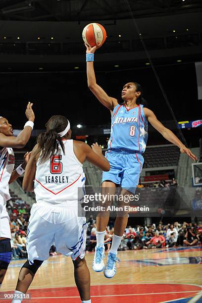 Iziane Castro Marques of the Atlanta Dream goes up for a shot attempt over Nikki Teasley of the Detroit Shock in Game One of the WNBA Eastern...