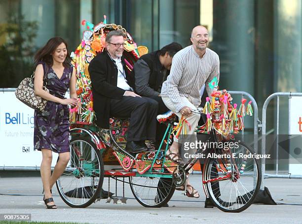 Producer David Hamilton and writer/director Dilip Mehta arrive via rickshaw at the "Cooking With Stella" screening during the 2009 Toronto...
