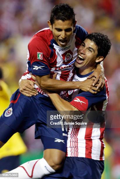 Alberto Medina and Jonny Magallon of Chivas de Guadalajara celebrate after a goal during the Mexican First Division "Clásico Nacional" match against...