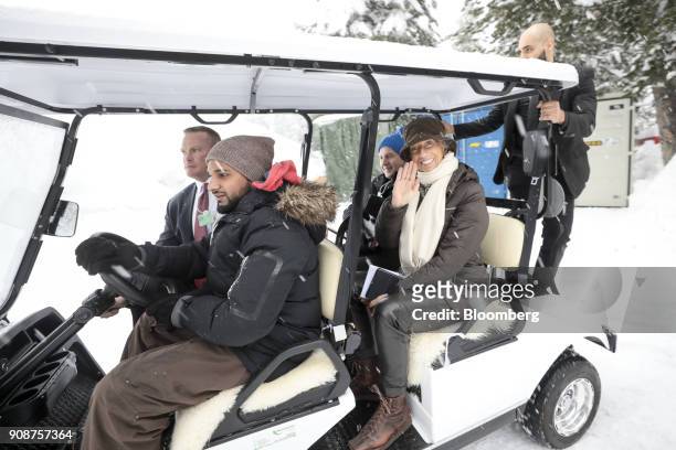 Christine Lagarde, managing director of the International Monetary Fund , waves as she uses an electric cart to move between venues ahead of the...