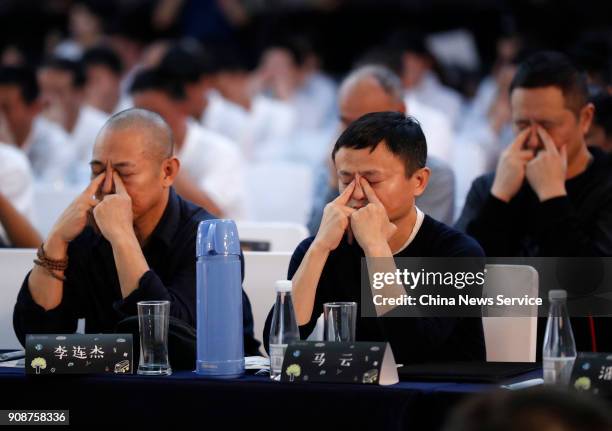 Alibaba Group Chairman Jack Ma and actor Jet Li do eye exercises during Jack Ma Foundation Rural Teachers Awards on January 22, 2018 in Sanya, China....