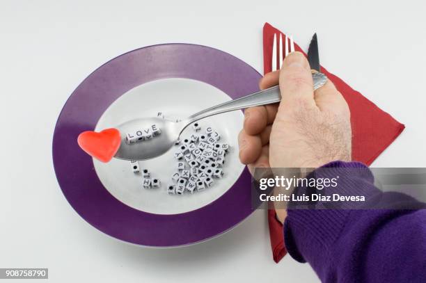 view of alphabet soup letters spelling love - pâtes alphabet photos et images de collection