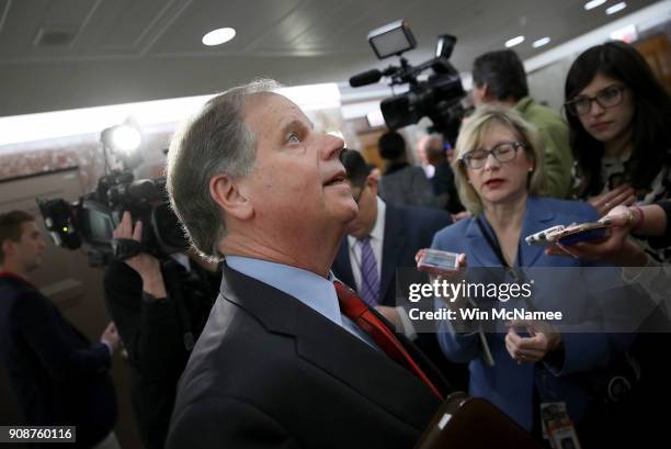 Sen. Doug Jones leaves the office of Sen. Susan Collins following a meeting with a bipartisan group of senators January 22, 2018 in Washington, DC....