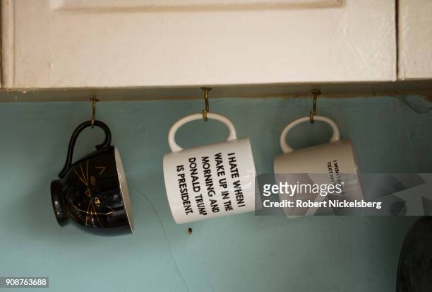 Coffee cup with a humorous text about US President Donald Trump is seen in a private apartment January 11, 2018 in Washington, DC.