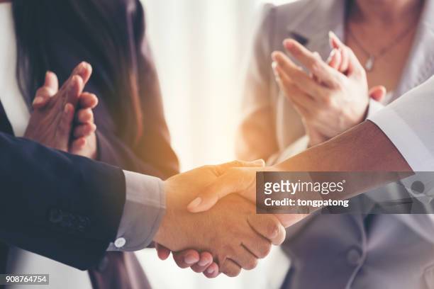 business people shaking hands in office - business relationship stock pictures, royalty-free photos & images