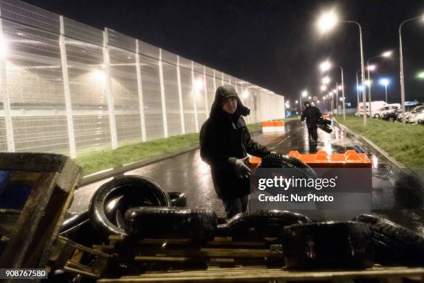 Protester lays down a tyre during a demonstration by prison guards where they blocked access to Fleury Merogis prison in France on January 22, 2018...