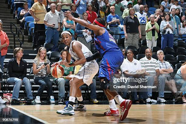 Candice Wiggins of the Minnesota Lynx moves the ball against Alexis Hornbuckle of the Detroit Shock during the game on September 9, 2009 at the...