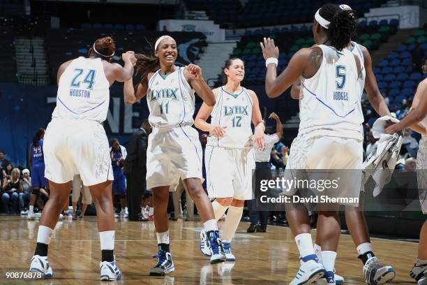 Candice Wiggins, Charde Houston and Roneeka Hodges of the Minnesota Lynx celebrate during the game against the Detroit Shock on September 9, 2009 at...