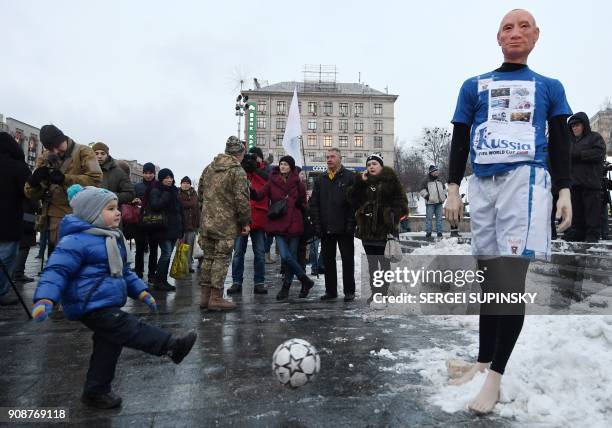Child kicks a ball at a mannequin depicting Russian President Vladimir Putin dressed in a football uniform, during the "Stop Putin. Stop war" rally...