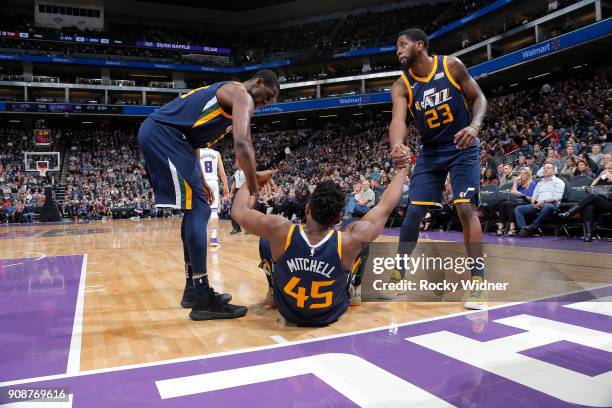 Ekpe Udoh and Royce O'Neale of the Utah Jazz help up teammate Donovan Mitchell during the game against the Sacramento Kings on January 17, 2018 at...