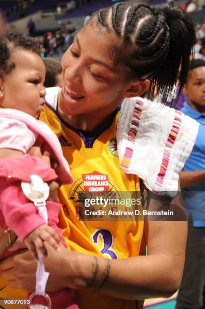 Candace Parker of the Los Angeles Sparks holds daughter Lailaa Nicole on the court after the win against the Seattle Storm in Game One of the WNBA...