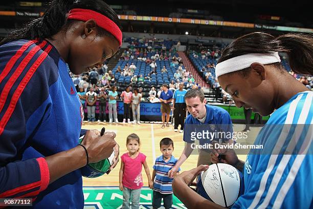 Cheryl Ford of the Detroit Shock and Candice Wiggins of the Minnesota Lynx sign autographs for fans prior to the game on September 9, 2009 at the...