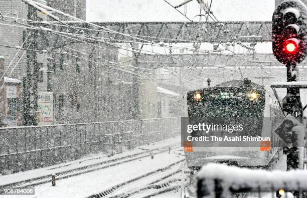 Chuo Line runs in the snow on January 22, 2018 in Mitaka, Tokyo, Japan. The Japan Meteorological Agency is forecasting 20 cm of snow in the Kanto,...