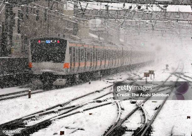 Chuo Line runs in the snow on January 22, 2018 in Mitaka, Tokyo, Japan. The Japan Meteorological Agency is forecasting 20 cm of snow in the Kanto,...