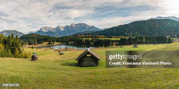 lodges with gerold lake and karwendel alps in the background. krün, upper bavaria, bavaria, germany. - bavarian forest stock pictures, royalty-free photos & images