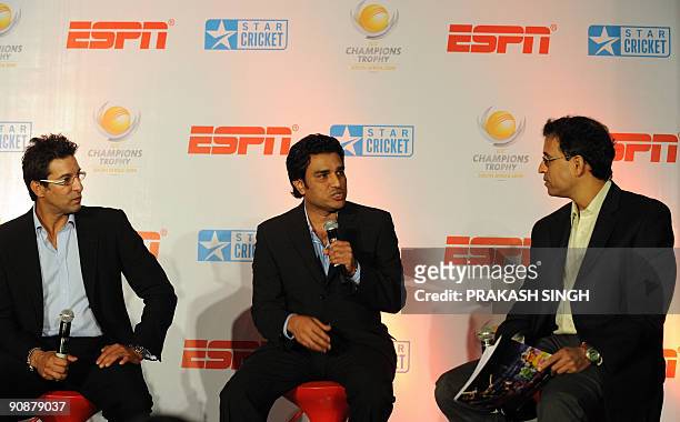 Star sports Commentators Harsha Bhogle and Wasim Akram listen to Sanjay Manjrekar during a press conference in New Delhi on September 17, 2009....