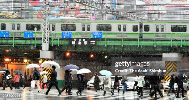 Commuters walk in the snow near the Shinjuku Station on January 22, 2018 in Tokyo, Japan. The Japan Meteorological Agency is forecasting 20 cm of...