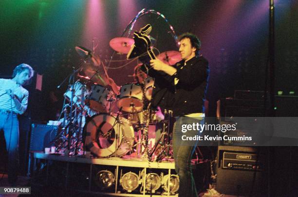 Singer Roger Daltrey looks on as Pete Townshend smashes another of his guitars during a performance with English rock group The Who at the Manchester...