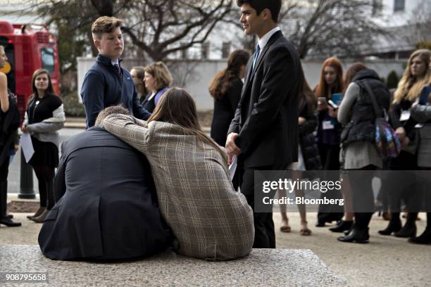 Visitors sit outside the Hart Senate Office building, closed due to the government shutdown, on Capitol Hill in Washington, D.C., U.S., on Monday,...