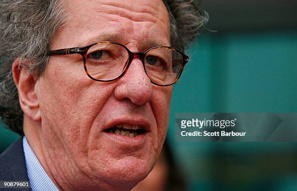Actor Geoffrey Rush poses for photographers as he arrives at the "Screen Worlds: The story of film, television and digital culture" exhibition...